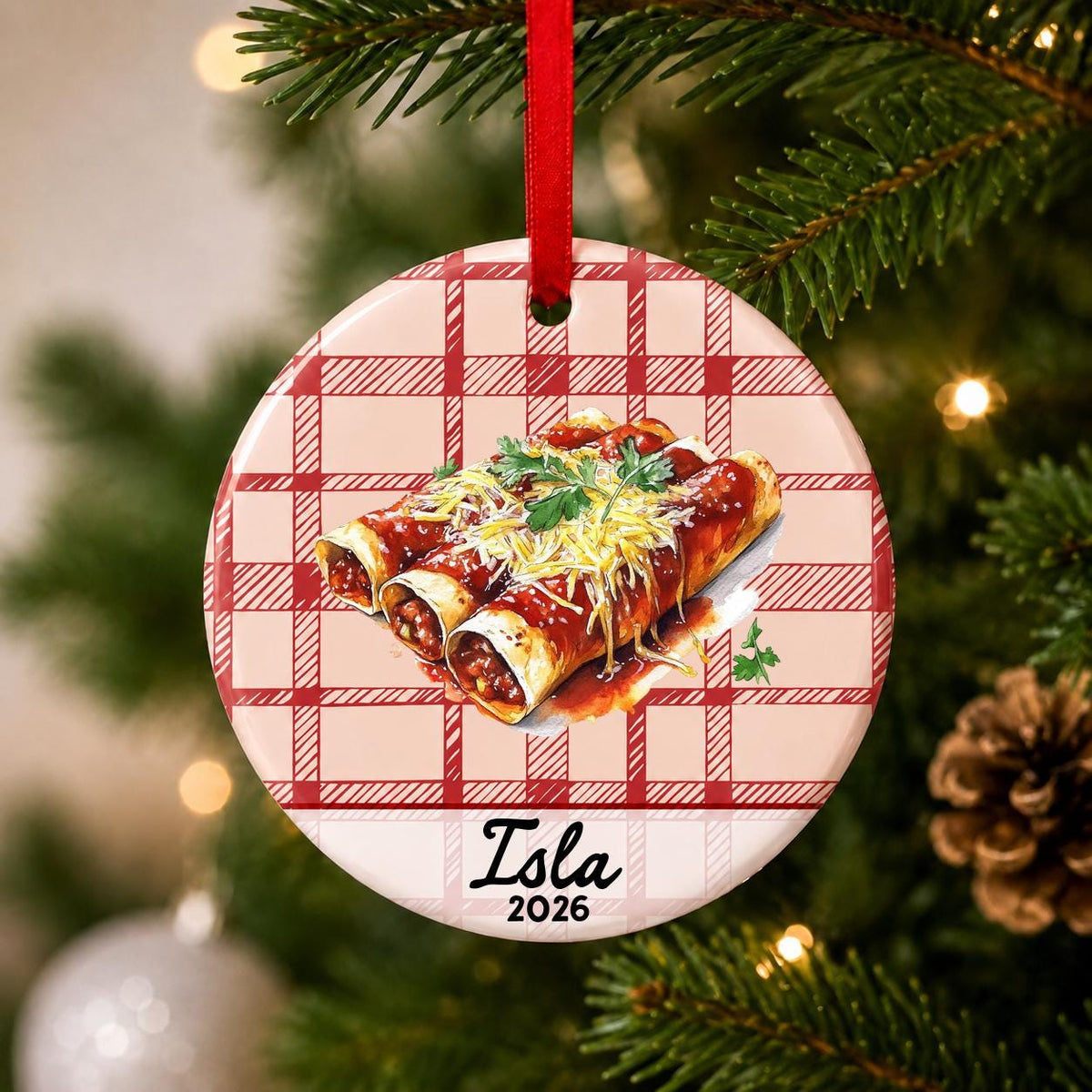 Close-up of the personalized enchilada ceramic ornament with name and year on red plaid hanging on a Christmas tree