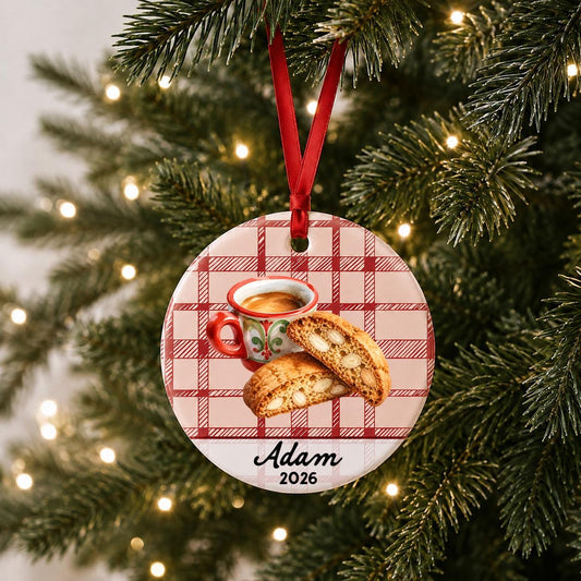 Personalized espresso and biscotti ceramic ornament with name and year on red plaid hanging on a lit Christmas tree