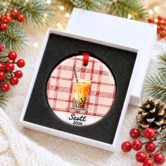 Personalized boba ceramic ornament with name and year on red plaid in a white gift box with protective foam