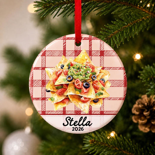Close-up of the personalized nachos ceramic ornament with name and year on red plaid hanging on a Christmas tree