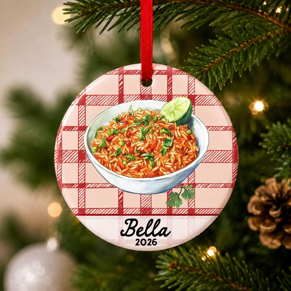 Close-up of the personalized Mexican rice ceramic ornament with name and year on red plaid hanging on a Christmas tree