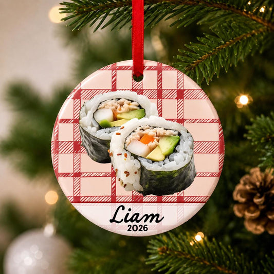 Close-up of the personalized sushi ceramic ornament with name and year on red plaid hanging on a Christmas tree