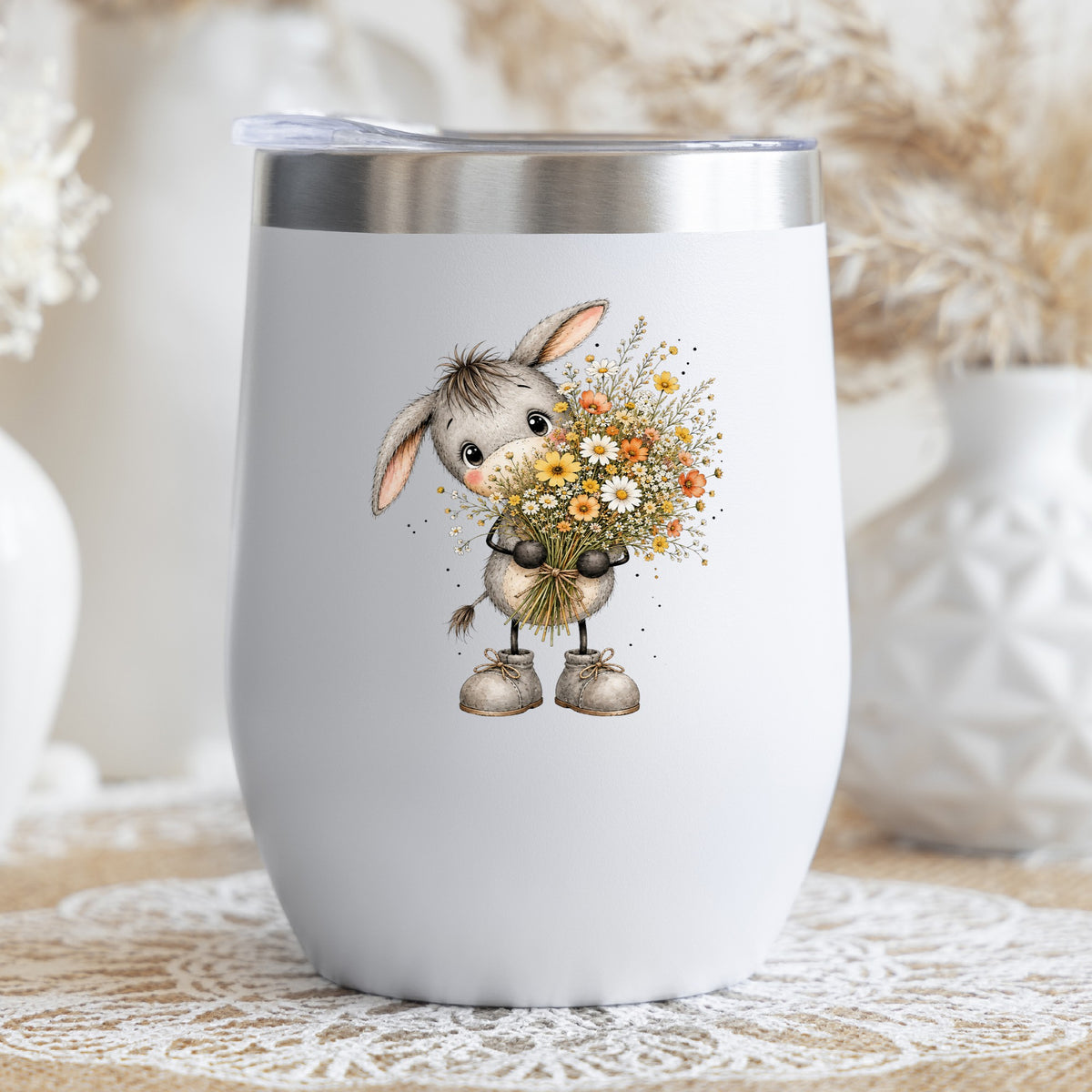 Baby Donkey Holding Wildflower Bouquet UV DTF sticker applied to a white stemless tumbler with a lid