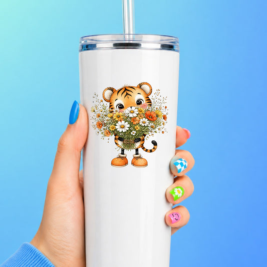 Tiger Cub Holding Wildflower Bouquet UV DTF sticker applied to a white straw tumbler on a blue background