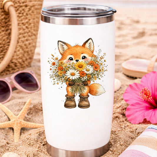 Watercolor Fox Holding Daisy Bouquet UV DTF sticker applied to a white travel tumbler on beach sand