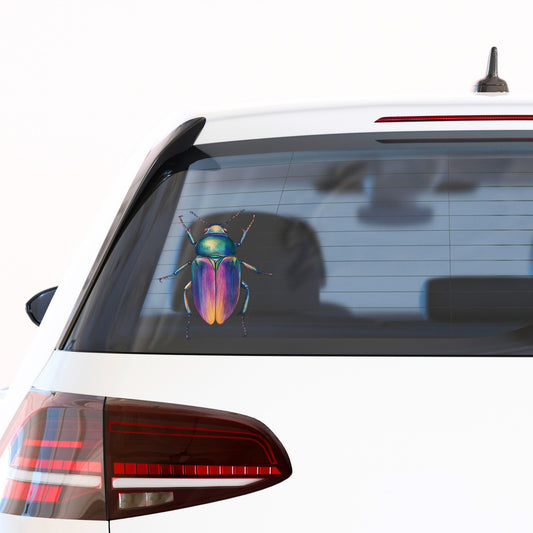 Rainbow Iridescent Beetle UV DTF sticker applied to the rear window of a white car
