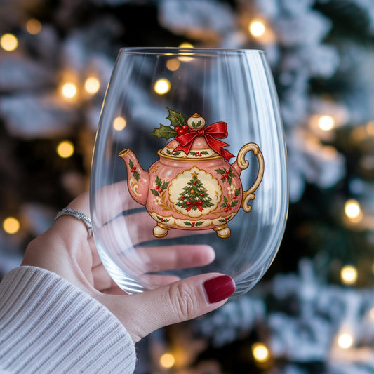 Pink Christmas Teapot With Holly UV DTF sticker applied to a stemless wine glass held in hand