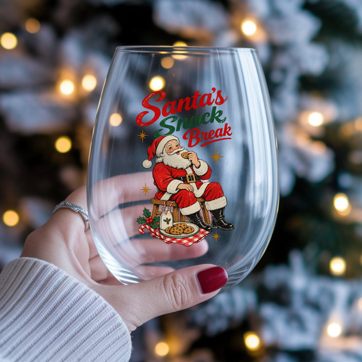 Santa's Snack Break Cookies UV DTF sticker applied to a stemless wine glass held in hand