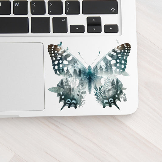 Black White Butterfly UV DTF sticker applied to a silver laptop beside the keyboard