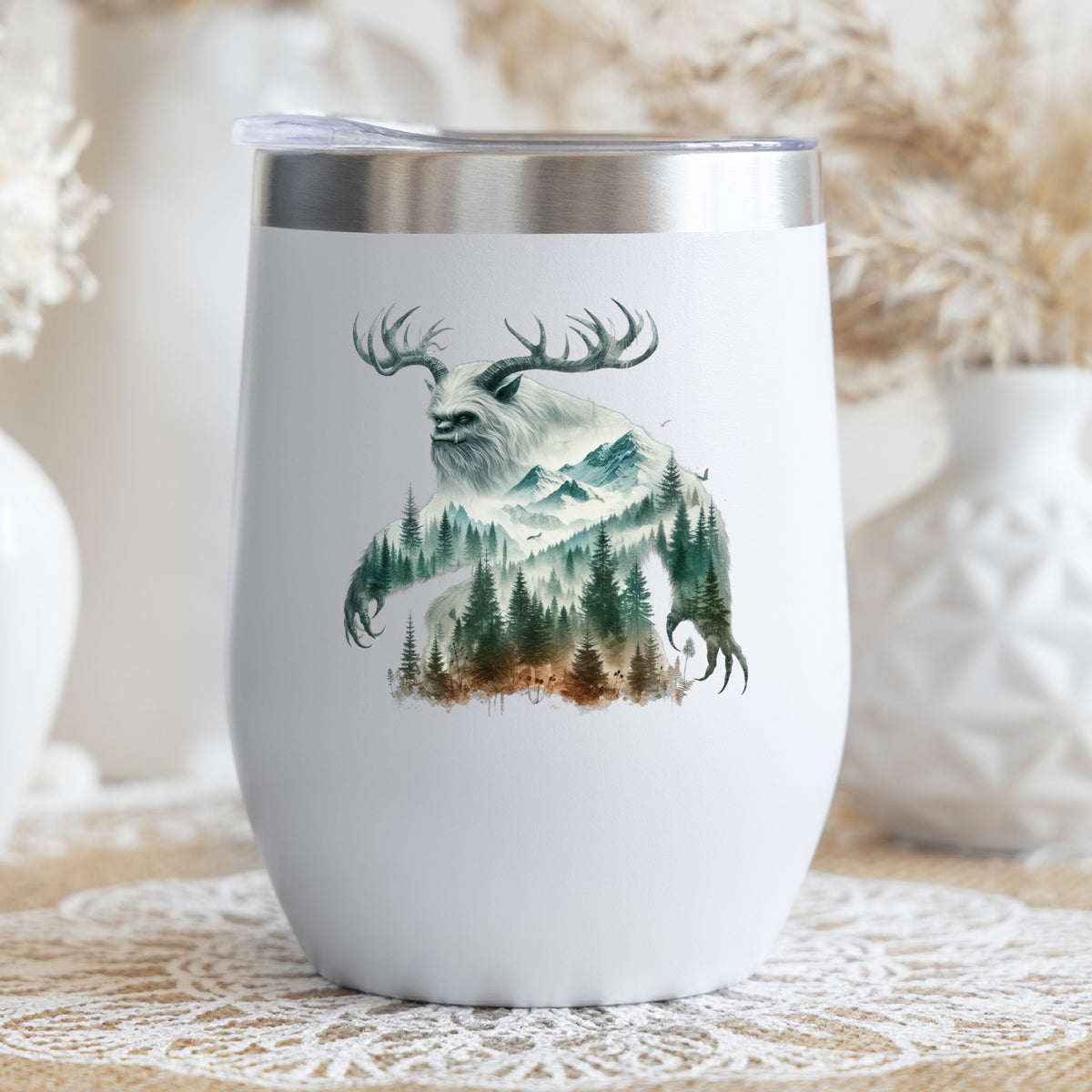 Antlered Mountain Bigfoot UV DTF sticker applied to a white stemless tumbler with a lid