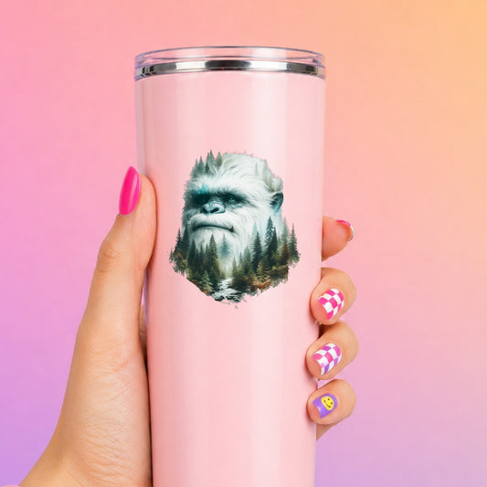 Bigfoot Face UV DTF sticker applied to a tall pink tumbler on a pink and orange background