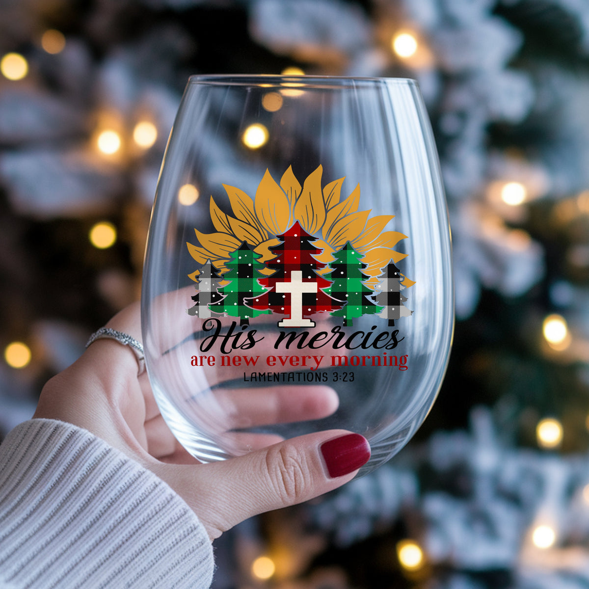 His Mercies Sunflower Christmas Tree UV DTF sticker applied to a stemless wine glass held in hand