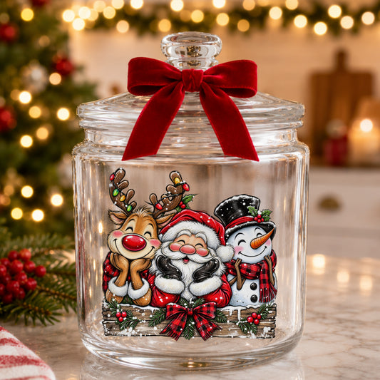 Santa Reindeer Snowman Plaid Bow UV DTF sticker applied to a glass candy jar tied with a red bow