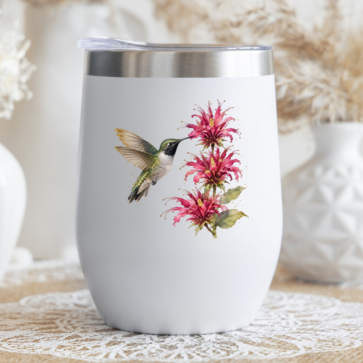 Hummingbird Pink Bee Balm UV DTF sticker applied to a white stemless tumbler with a lid
