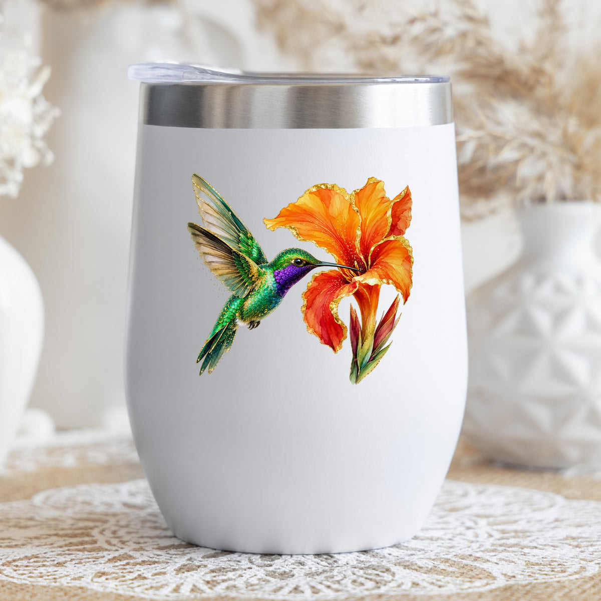 Hummingbird Orange Canna Lily UV DTF sticker applied to a white stemless tumbler with a lid