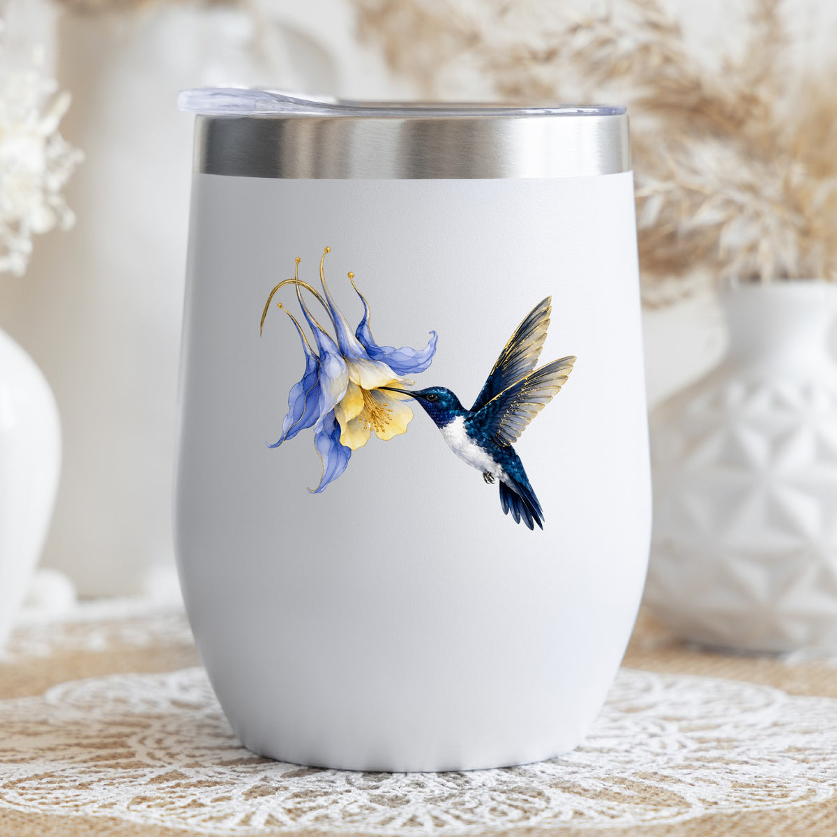 Navy Hummingbird Blue Columbine UV DTF sticker applied to a white stemless tumbler with a lid
