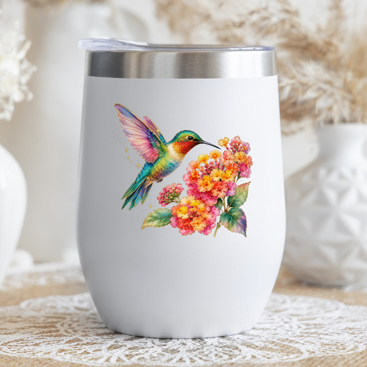Rainbow Hummingbird Lantana UV DTF sticker applied to a white stemless tumbler with a lid