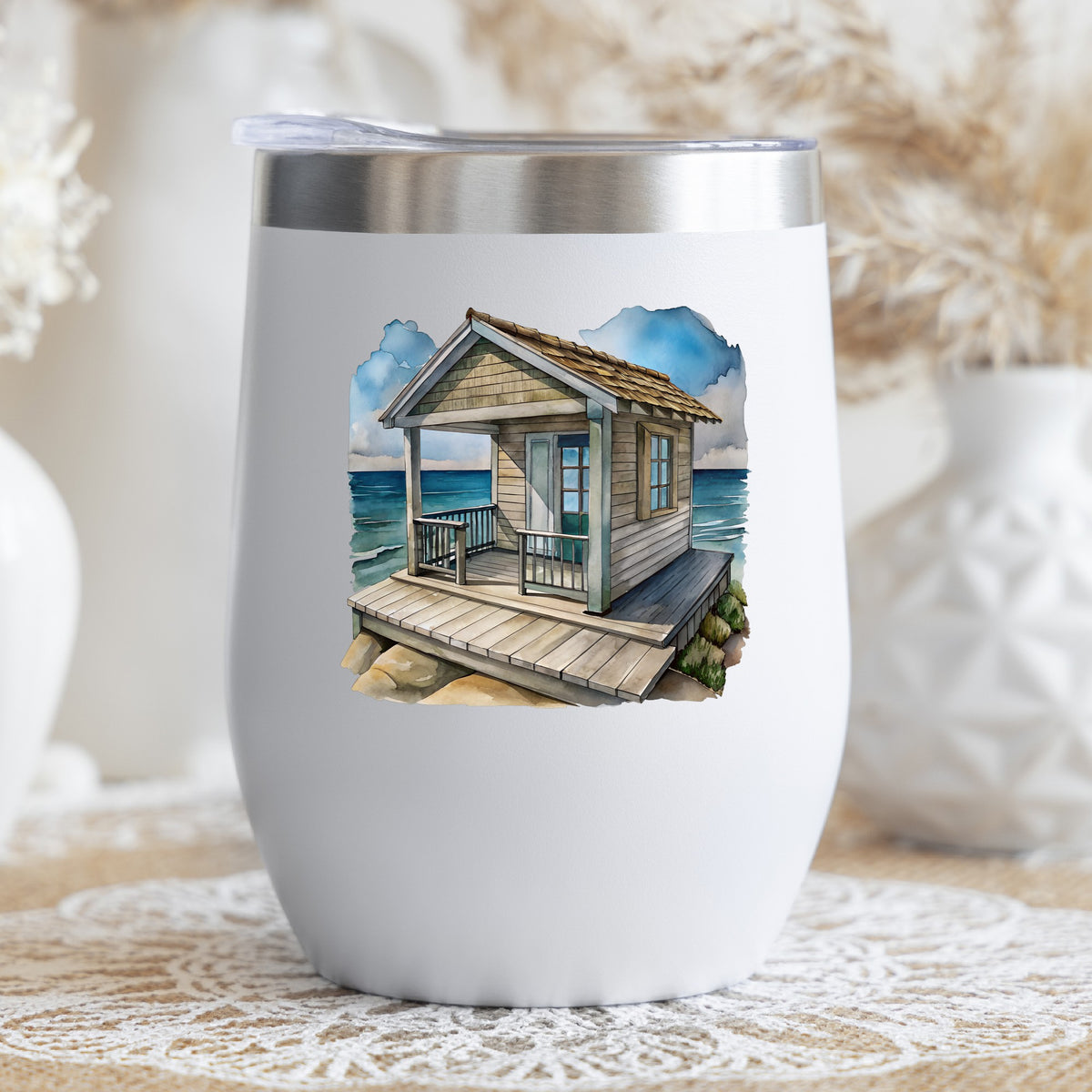 Beach Cottage Porch Ocean View UV DTF sticker applied to a white stemless tumbler with a lid
