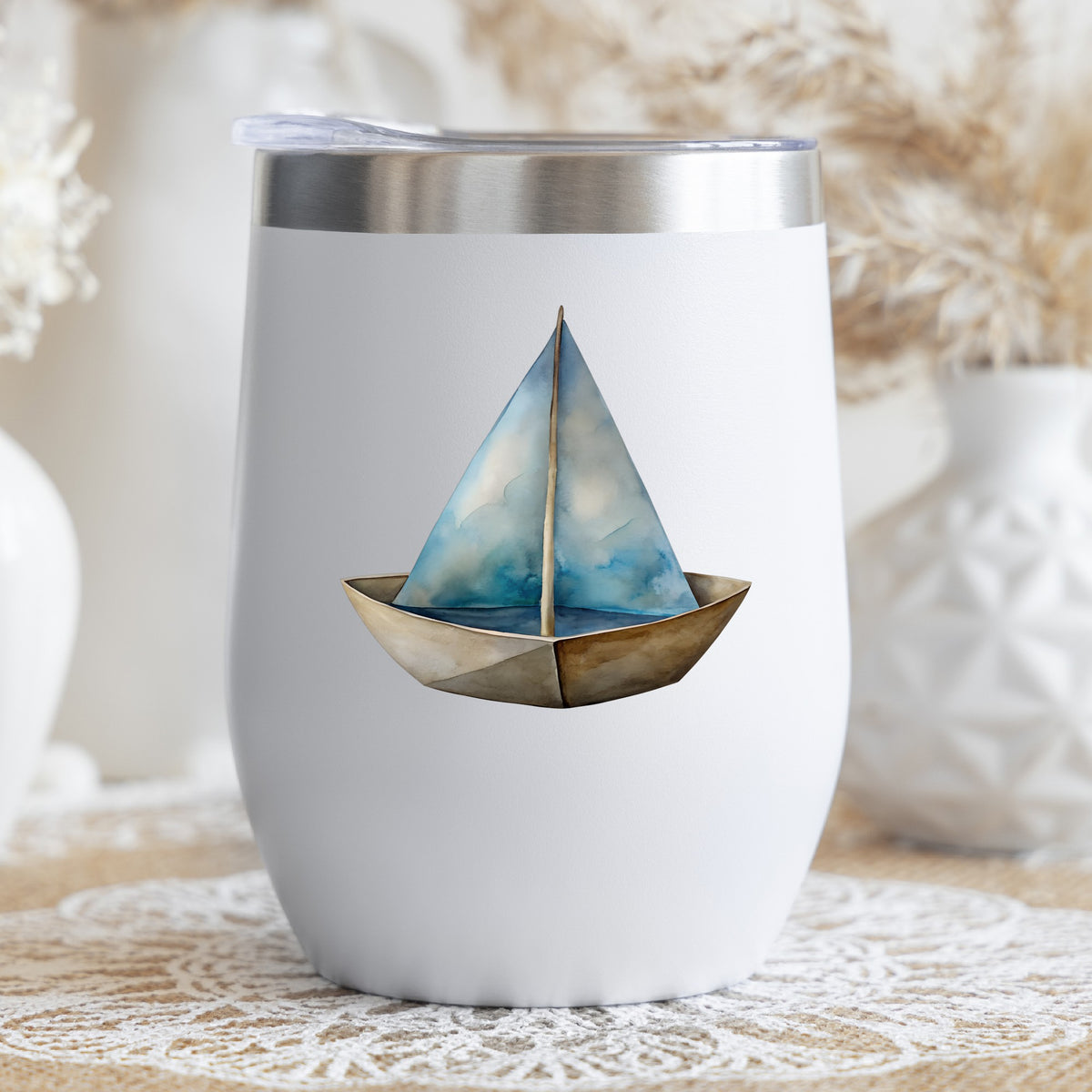 Paper Sailboat UV DTF sticker applied to a white stemless tumbler with a lid