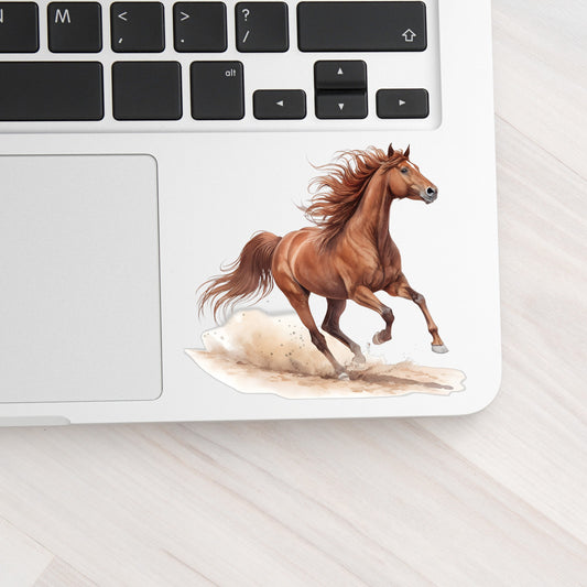 Chestnut Horse Galloping UV DTF sticker applied to a silver laptop beside the keyboard