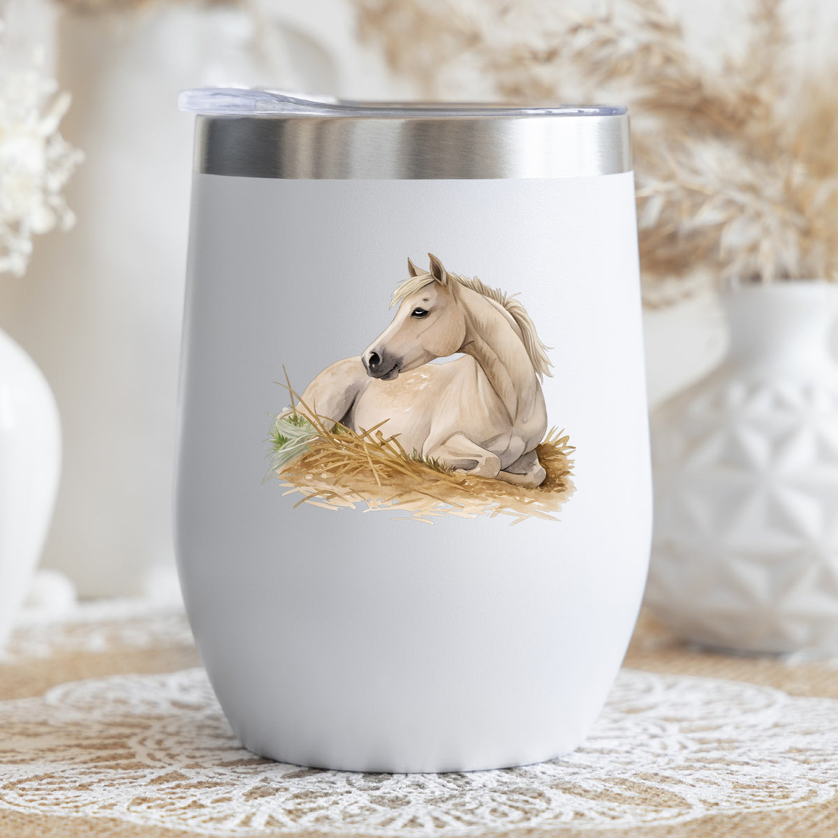 Cream Horse Resting In Hay UV DTF sticker applied to a white stemless tumbler with a lid