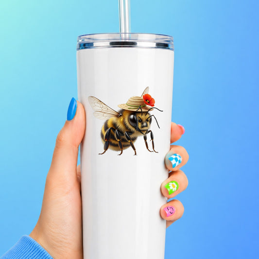Bee In Straw Hat With Red Poppy UV DTF sticker applied to a white straw tumbler on a blue background