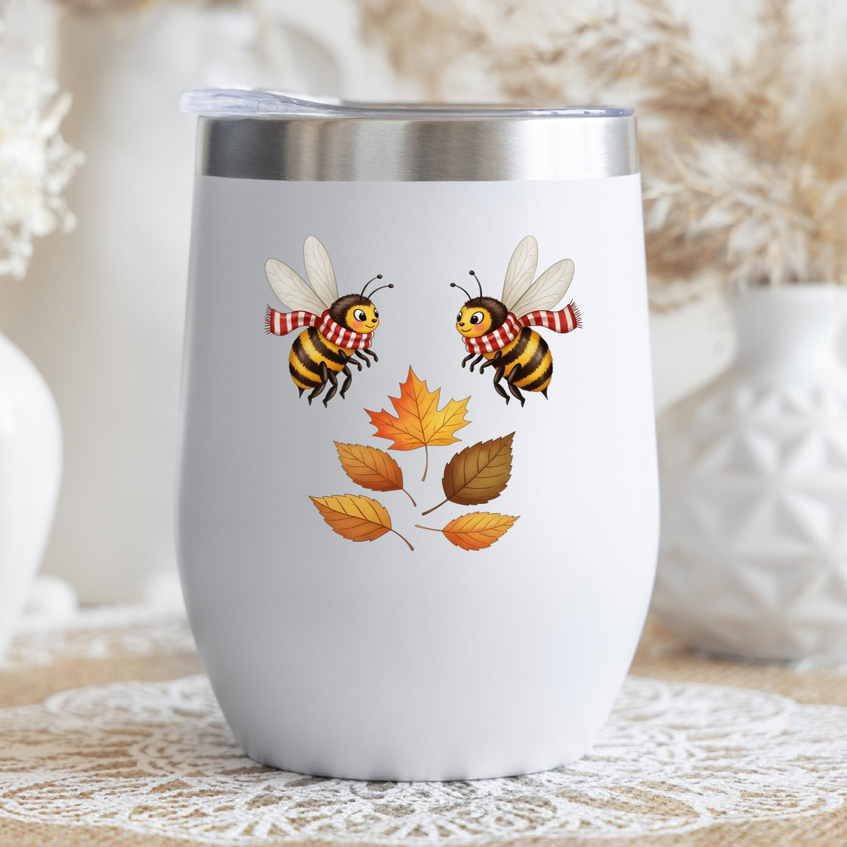 Two Bees With Autumn Leaves UV DTF sticker applied to a white stemless tumbler with a lid