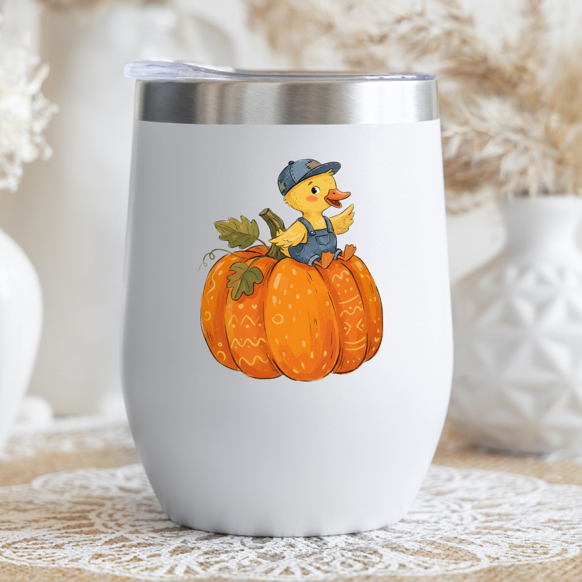 Duckling In Overalls On Pumpkin UV DTF sticker applied to a white stemless tumbler with a lid
