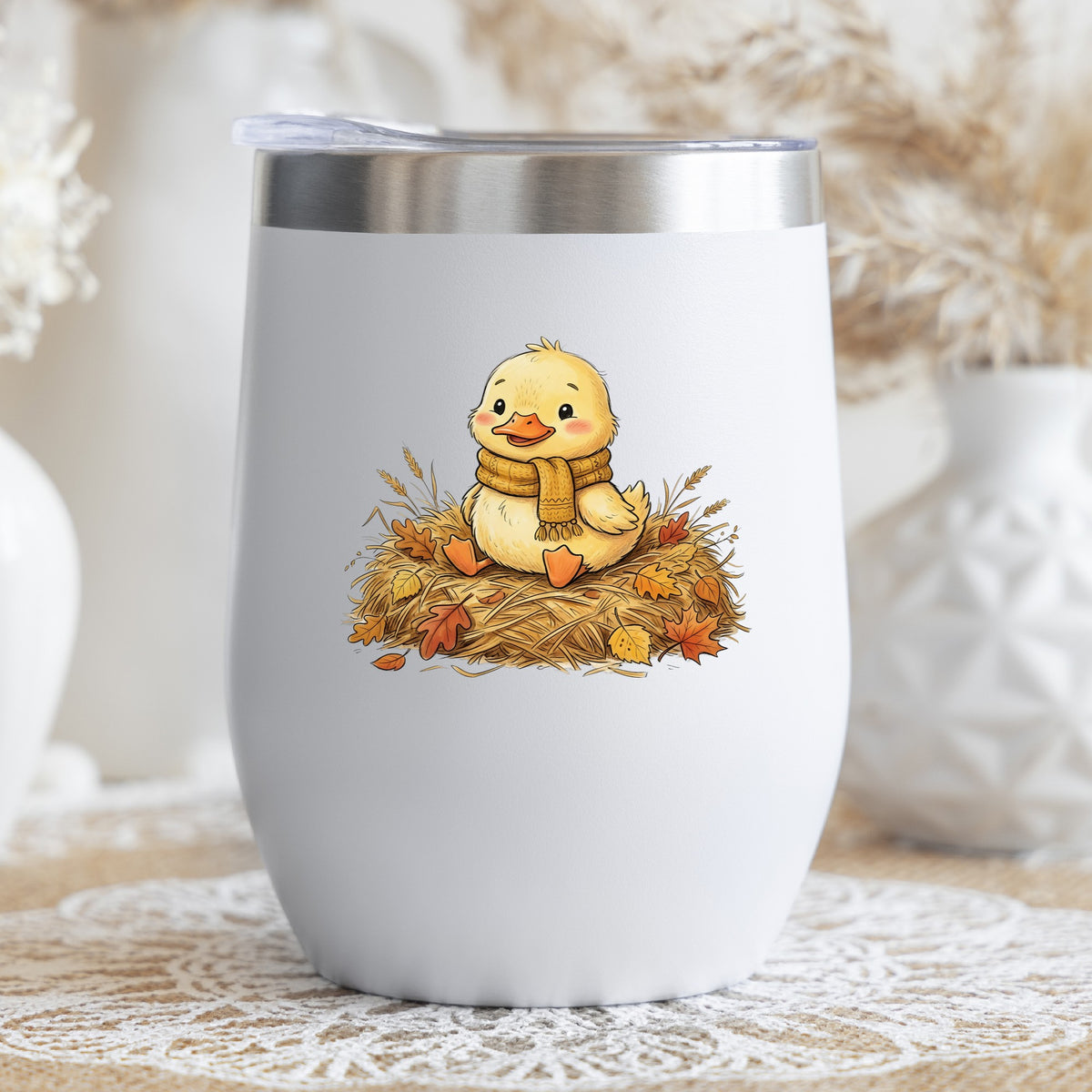 Duckling In Scarf On Hay With Autumn Leaves UV DTF sticker applied to a white stemless tumbler with a lid