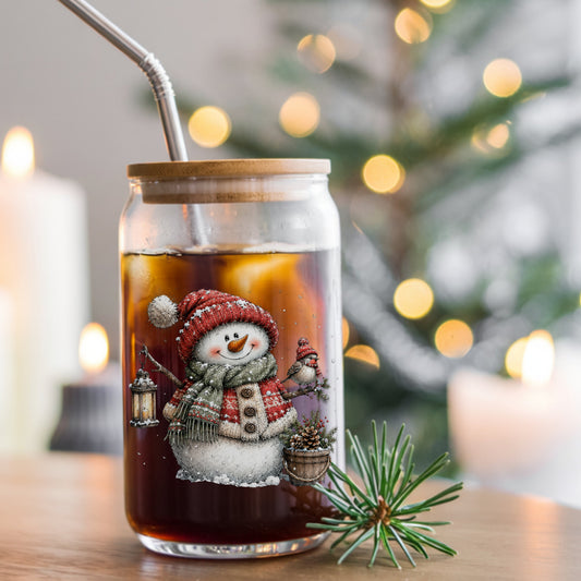 Fair Isle Sweater Snowman With Bird UV DTF sticker applied to a glass can cup of iced coffee with a straw