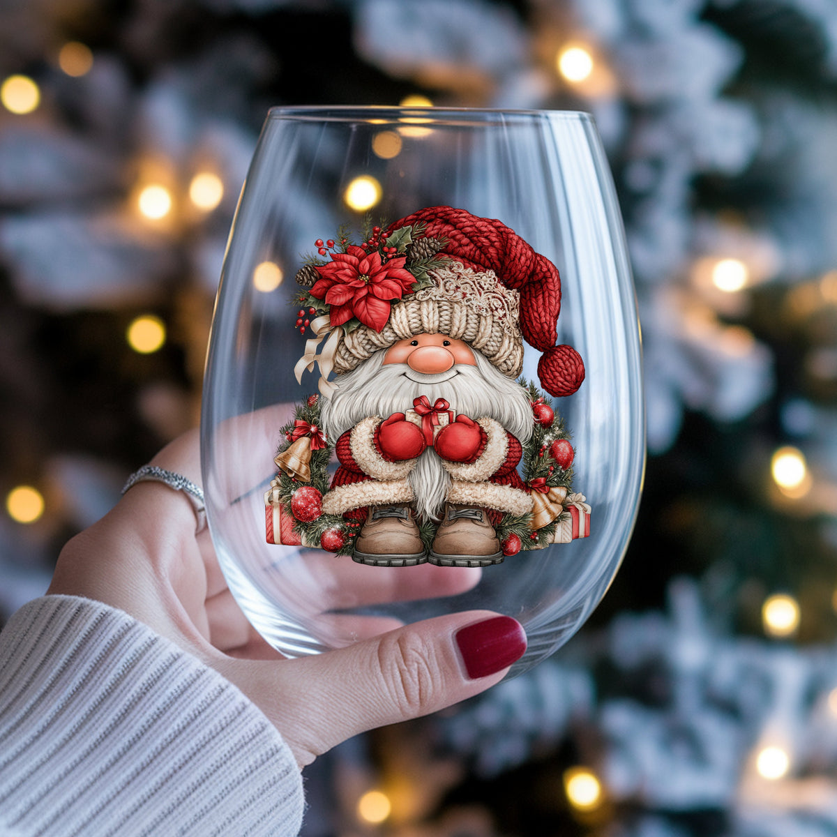 Gnome With Gold Bells And Cream Hat UV DTF sticker applied to a stemless wine glass held in hand