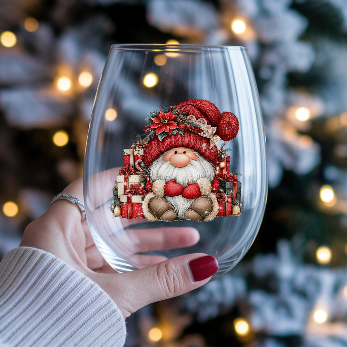 Gnome With Pile Of Presents UV DTF sticker applied to a stemless wine glass held in hand
