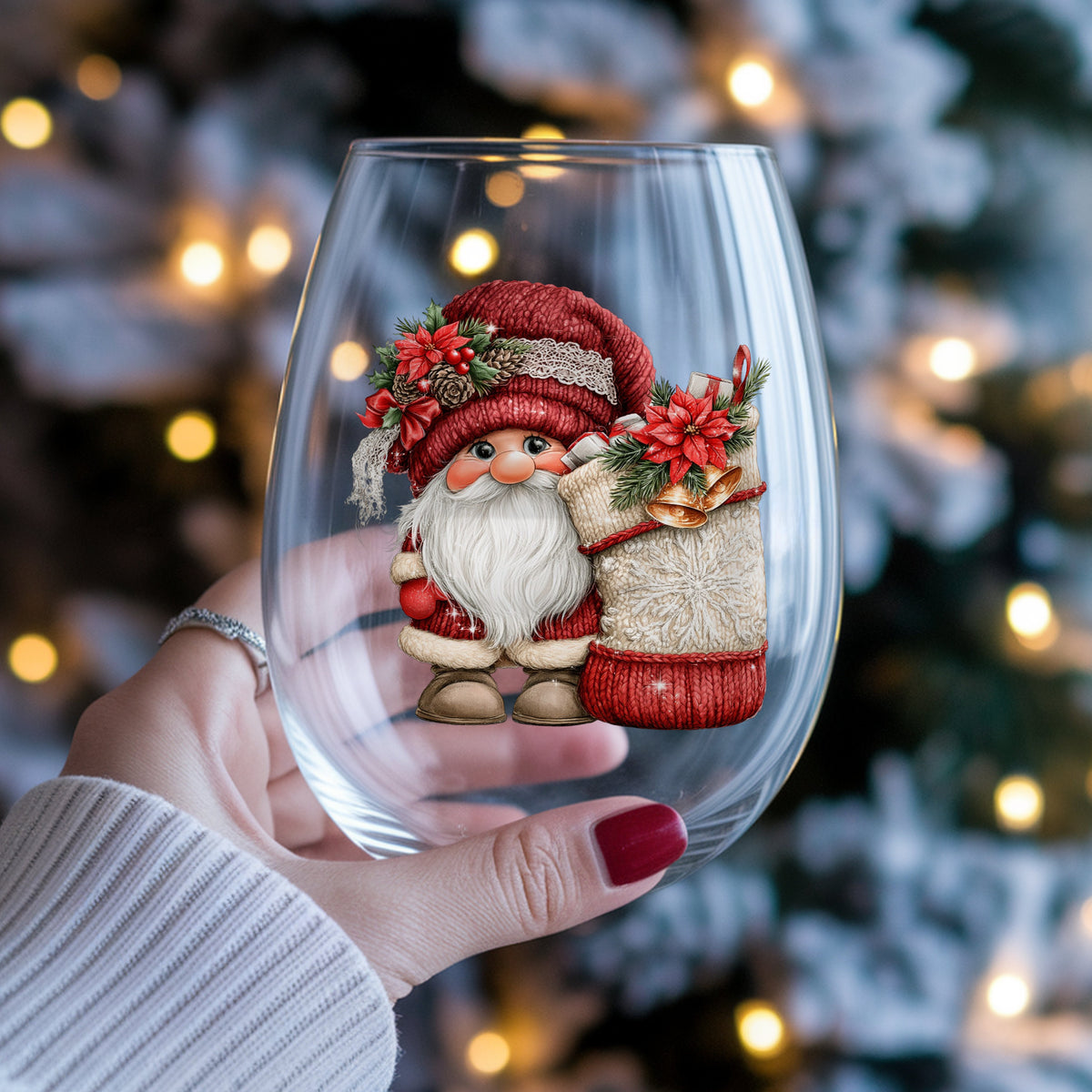 Gnome With Knit Christmas Stocking UV DTF sticker applied to a stemless wine glass held in hand