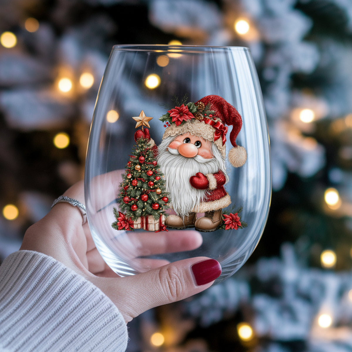 Gnome Putting Star On Christmas Tree UV DTF sticker applied to a stemless wine glass held in hand