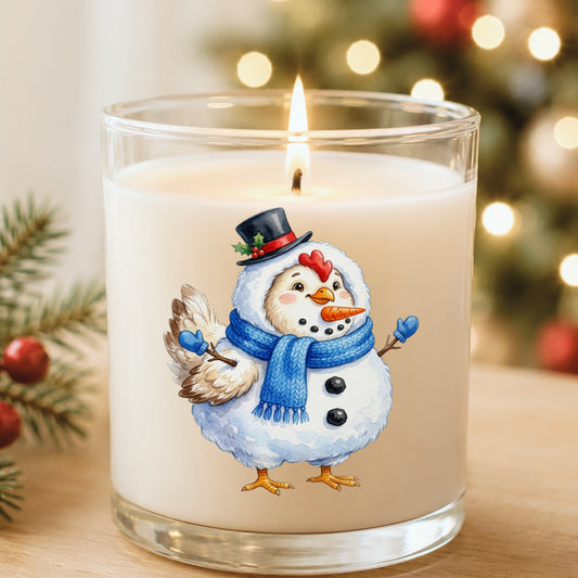 Chicken In Snowman Costume UV DTF sticker applied to a white candle in a glass holder near Christmas lights