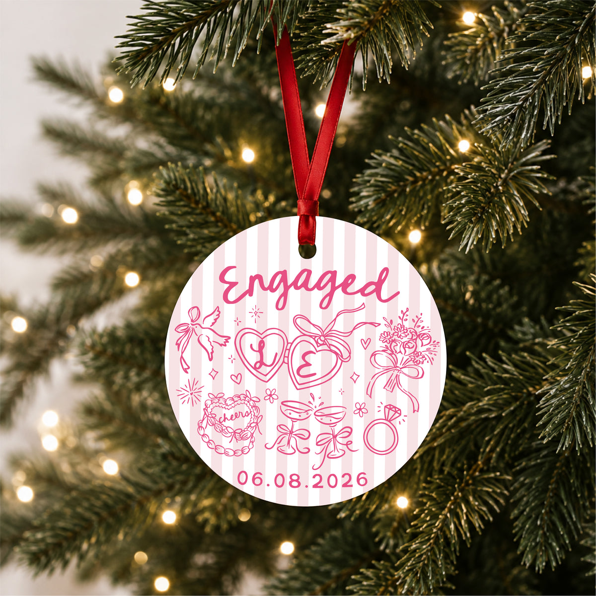 Personalized pink striped engagement ornament with initials and full date, hanging on a lit Christmas tree