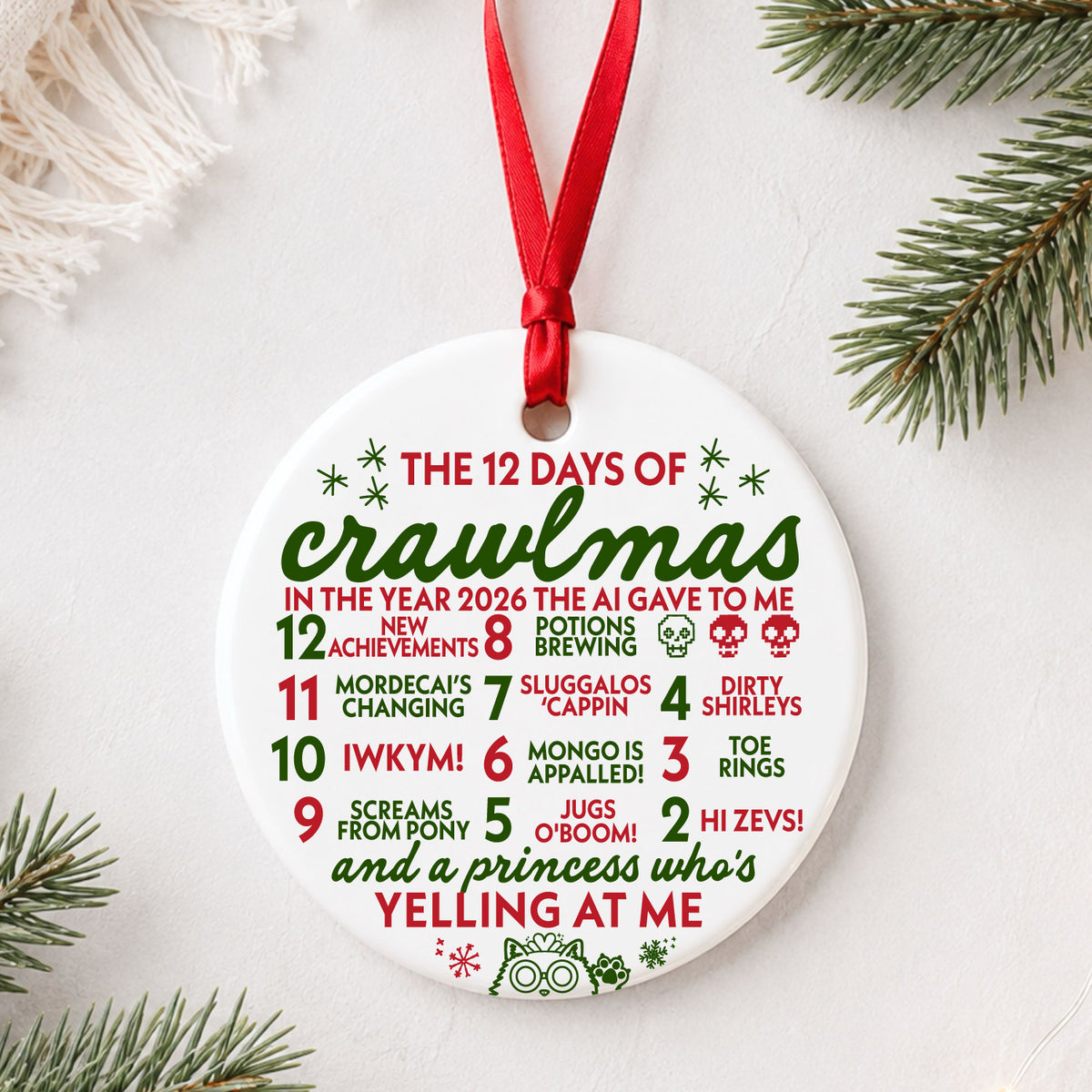 12 Days of Crawlmas Dungeon Crawler Carl ornament in red and green with red ribbon beside evergreen branches