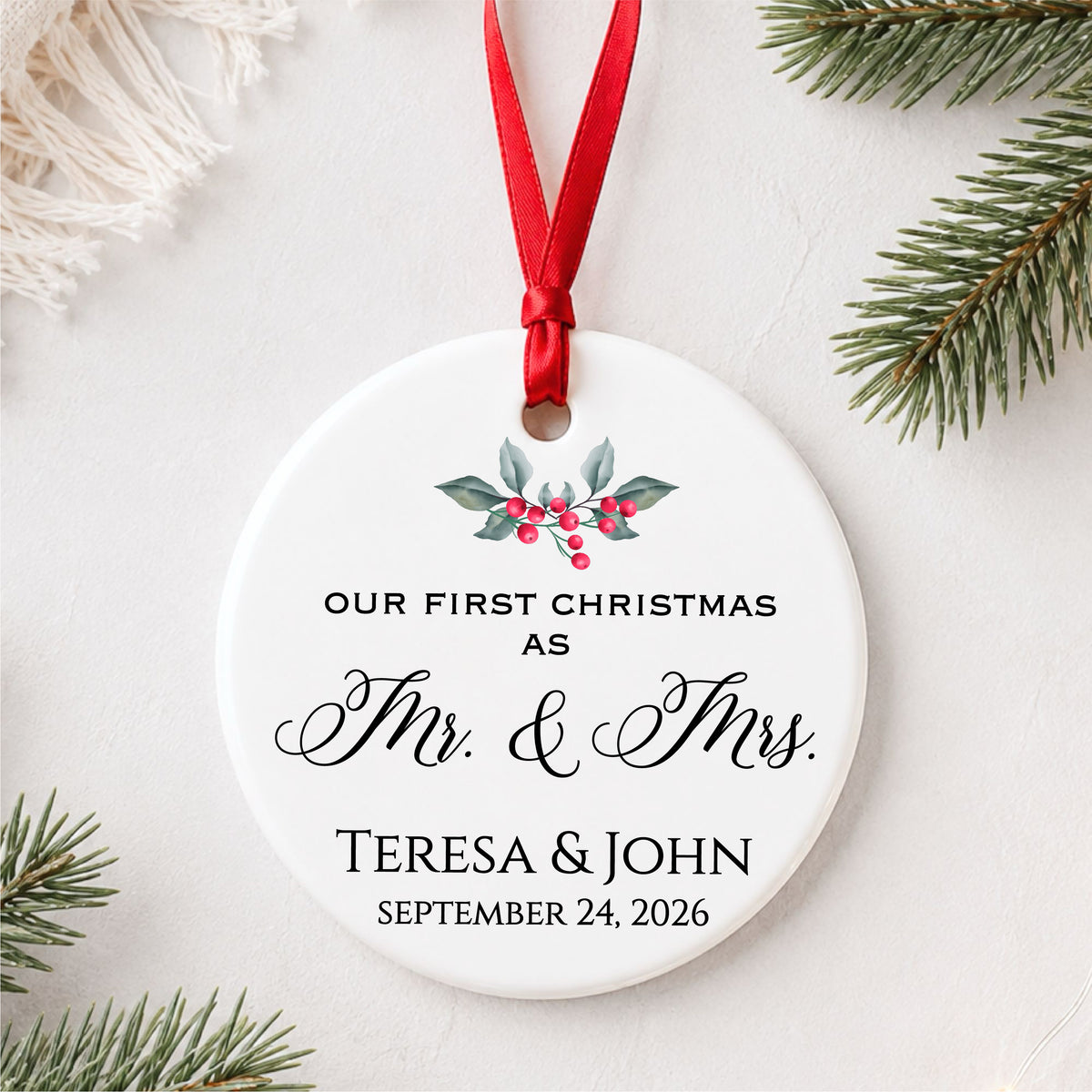 Personalized first Christmas as Mr. and Mrs. ornament with holly, couple names and wedding date, styled flat lay hero view