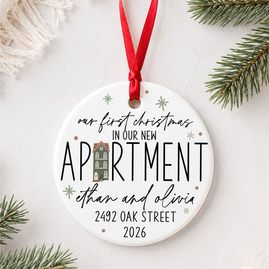 Personalized first Christmas in our new apartment ornament with address, names and year, styled flat lay hero view