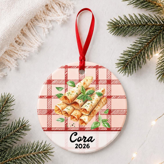 Personalized taquito ceramic ornament with name and year on red plaid styled with pine branches on a soft white background