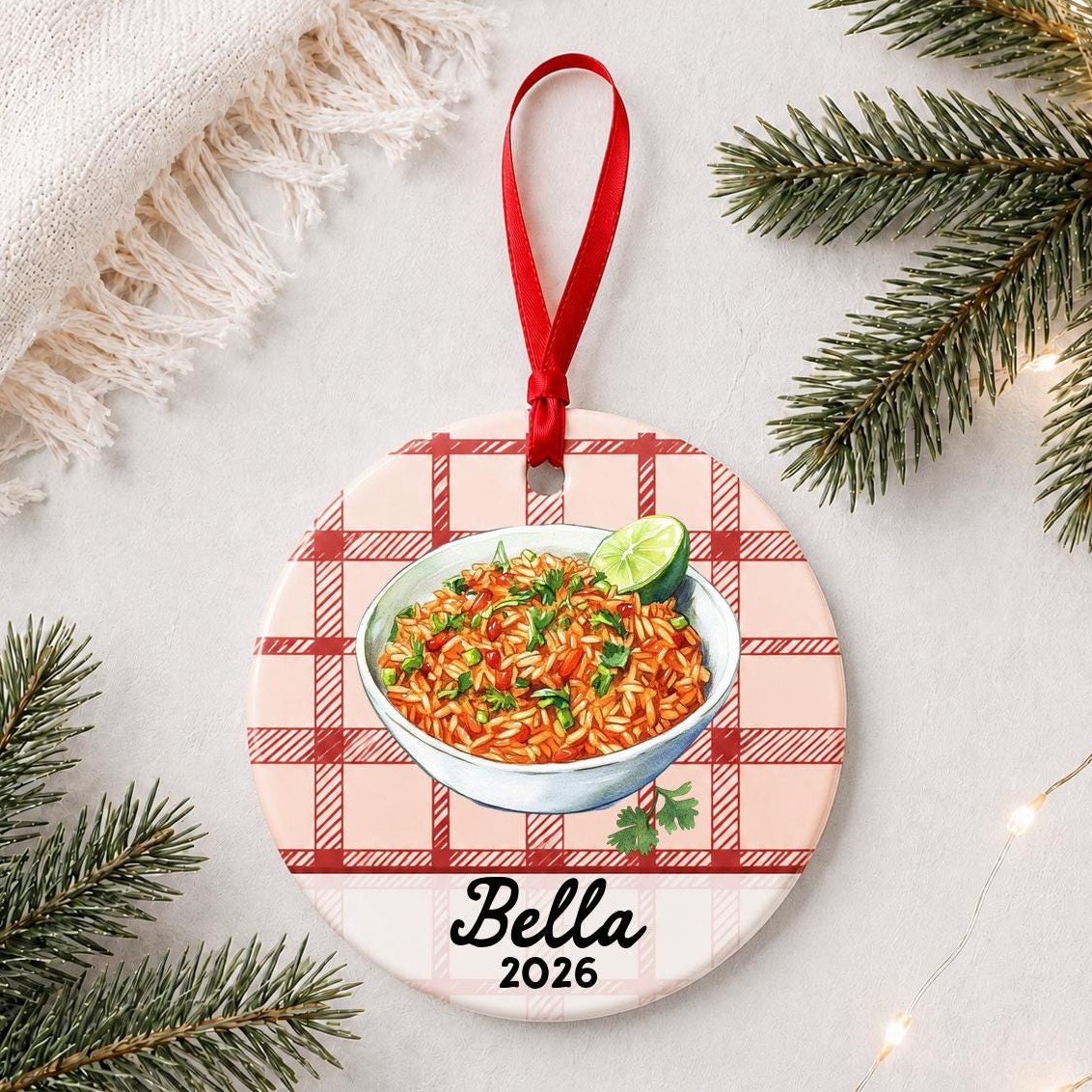 Personalized Mexican rice ceramic ornament with name and year on red plaid styled with pine branches on a soft white background