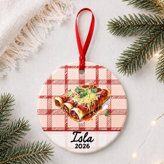 Personalized enchilada ceramic ornament with name and year on red plaid styled with pine branches on a soft white background