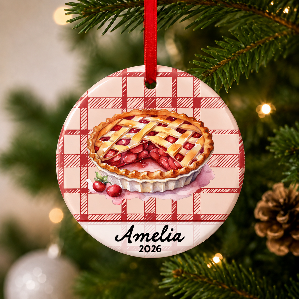 Personalized cherry pie ceramic Christmas ornament with name and year hanging on a Christmas tree