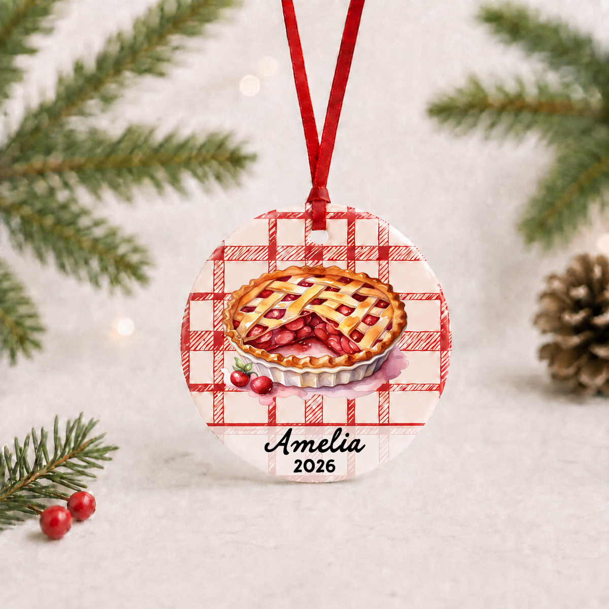 Personalized cherry pie ceramic ornament hanging against a light holiday background