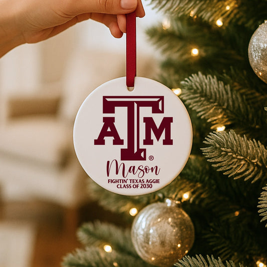 Personalized Texas A&M ornament with maroon ribbon hanging on a Christmas tree