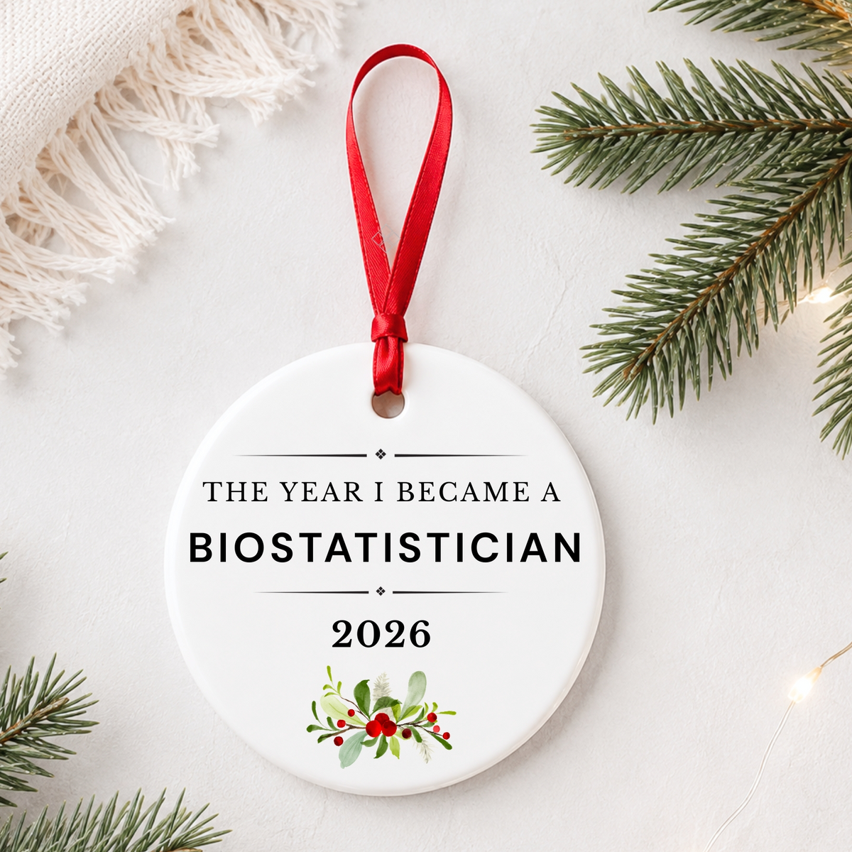 Biostatistician 2026 ceramic ornament reading The Year I Became a Biostatistician styled with pine branches on a soft white background