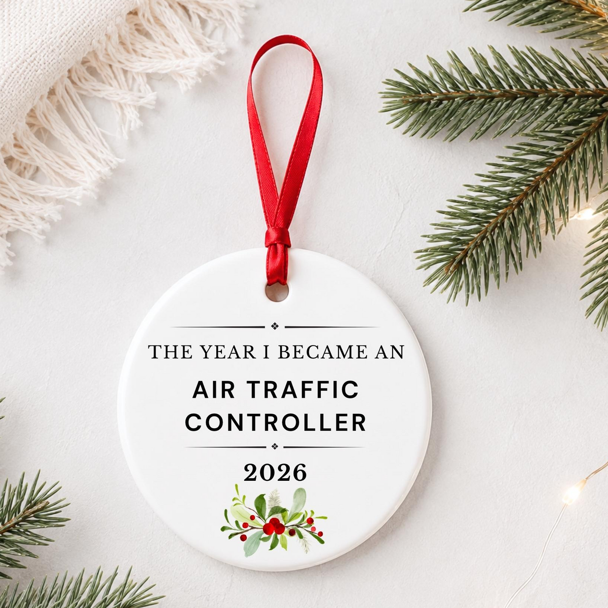 Air Traffic Controller 2026 ceramic ornament reading The Year I Became an Air Traffic Controller styled with pine branches on a soft white background