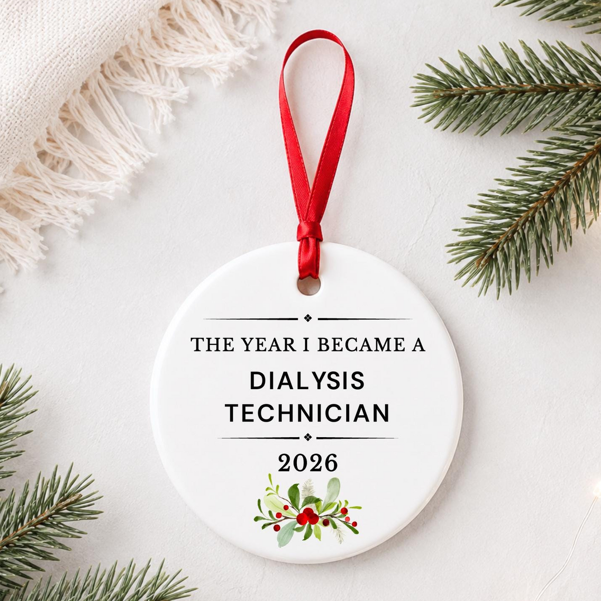 Dialysis Technician 2026 ceramic ornament reading The Year I Became a Dialysis Technician styled with pine branches on a soft white background