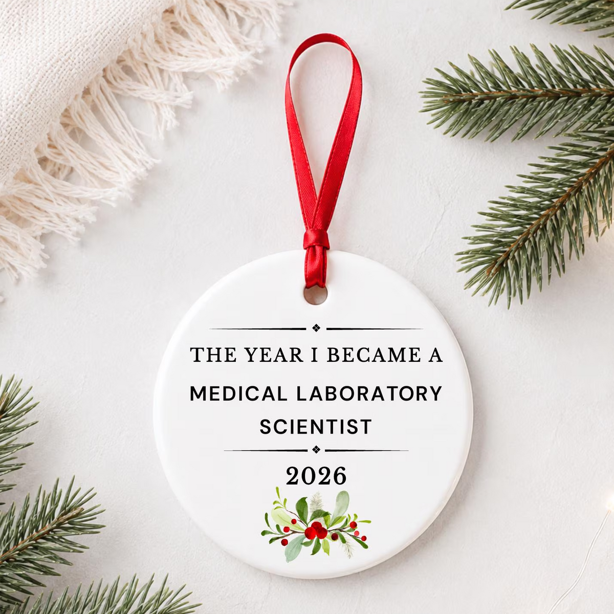 Medical Laboratory Scientist 2026 ceramic ornament reading The Year I Became a Medical Laboratory Scientist styled with pine branches on a soft white background