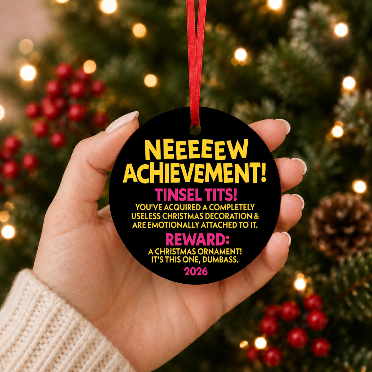 Dungeon Crawler Carl New Achievement ornament held in hand in front of a lit Christmas tree